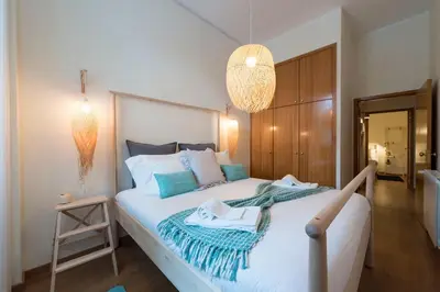 a bedroom with a large white bed with blue accents at LovelyStay - The Porto Getaway w/ Free Parking in Porto