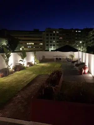 a large building with a yard at night at Casa Jardim in Porto
