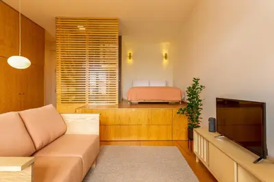 a table with flowers on it in a room with windows at Tripas-Coração, Cordoaria River View, Garden View or Loft in Porto