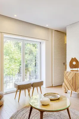 a living room with a table and a large window at Wood Premium Downtown Apartment by DA'HOME in Porto