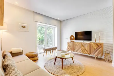 a living room with a couch and a tv at Wood Premium Downtown Apartment by DA'HOME in Porto