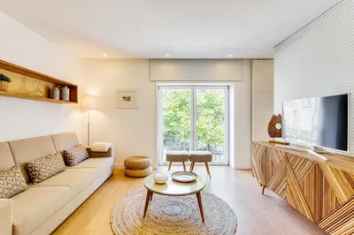 a living room with a couch and a tv at Wood Premium Downtown Apartment by DA'HOME in Porto