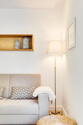 a living room with a couch and a lamp at Wood Premium Downtown Apartment by DA'HOME in Porto
