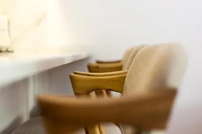 a row of chairs sitting next to a table at Wood Premium Downtown Apartment by DA'HOME in Porto
