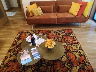 a living room with a table and a couch at Architect House in Porto