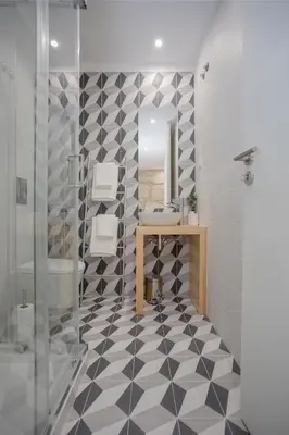 a bathroom with a black and white checkered floor at Liiiving in Porto - Charming Downtown Delight in Porto