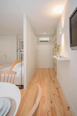 a small apartment with a bedroom and a living room at Liiiving in Porto - Charming Downtown Delight in Porto