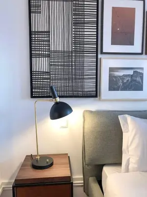 a lamp on a table next to a bed at Oporto Chic&Cozy - Aliados in Porto