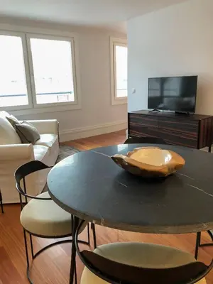a living room with a table and a tv at Oporto Chic&Cozy - Aliados in Porto