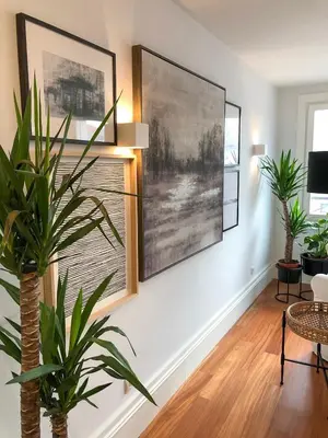 a living room with two large paintings on the wall at Oporto Chic&Cozy - Aliados in Porto