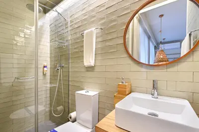 a bathroom with a toilet and a sink and a mirror at Sleep in Office in Porto