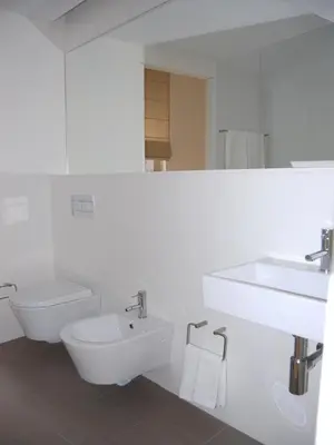 a white bathroom with a sink and a toilet at Top Flat in Porto