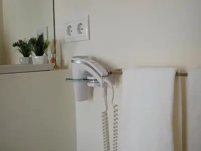 a hair dryer is attached to a shower curtain at Top Flat in Porto