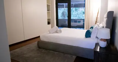 a bedroom with a large white bed with blue pillows at LUXURY VIEWS by YoursPorto in Vila Nova de Gaia