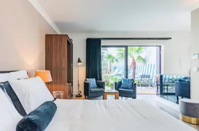 a bedroom with a large bed and a balcony at Maison Cabral in Porto