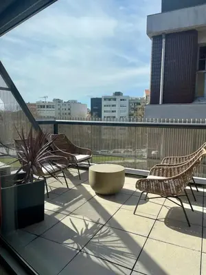 a balcony with chairs and a table on a building at QP Trindade Apartments in Porto