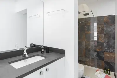 a bathroom with a sink and a toilet at QP Trindade Apartments in Porto