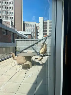a balcony with a table and chairs on a building at QP Trindade Apartments in Porto