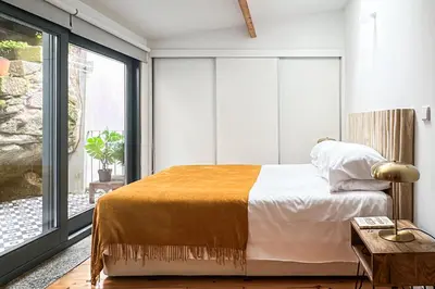 a bedroom with a bed and a large window at Relax Porto Studio by Own Places in Porto