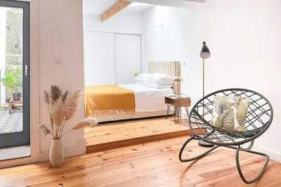 a white bedroom with a bed and a chair at Relax Porto Studio by Own Places in Porto