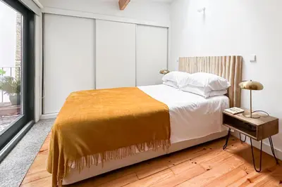 a bedroom with a bed and a large window at Relax Porto Studio by Own Places in Porto