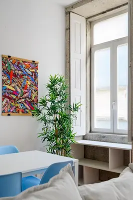 a dining room with a table and a window at Spacious Duplex in Porto's Downtown • A/C in Porto