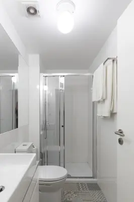 a white bathroom with a shower and a toilet at Porto Historical Center Apartments in Porto