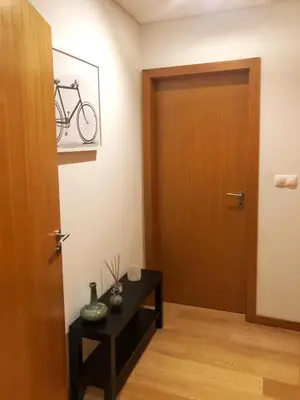 a room with a door and a table with a bike on the wall at InPorto in Porto