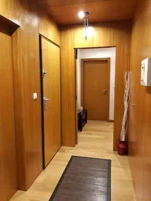 a hallway with wooden walls and a door and a rug at InPorto in Porto