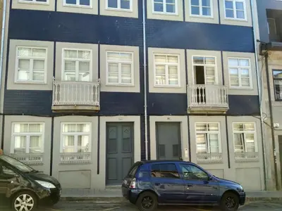 a blue car parked in front of a building at Boavista Garden Apartment in Porto