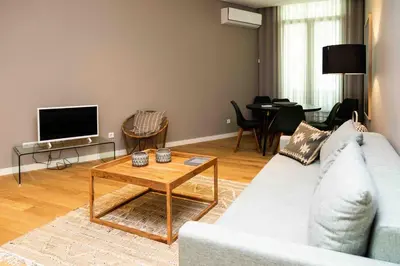 a living room with a couch and a table at VIVA Size Flats Clérigos in Porto