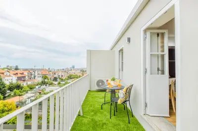 a bedroom with a large bed and a kitchen at Studio 183 in Porto