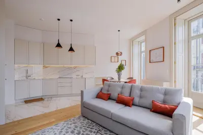 a living room with a couch and a kitchen at BOUTIQUE Rentals-Kihara’s Ribeira Apt with great views in Porto
