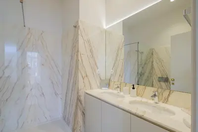 a bathroom with two sinks and a large mirror at BOUTIQUE Rentals-Kihara’s Ribeira Apt with great views in Porto