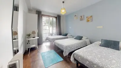 a bedroom with two beds and a window at Vivenda Center Porto in Porto