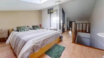 a bedroom with a large bed and a bathroom at Vivenda Center Porto in Porto