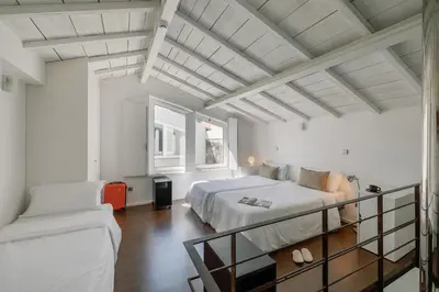 a white bedroom with a bed and a couch at Fine Arts Studios by Olala Homes in Porto