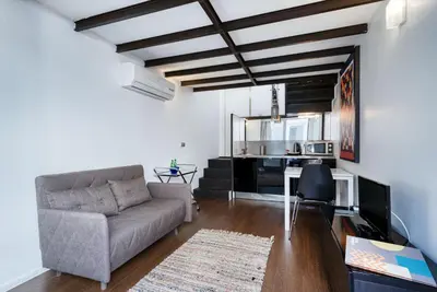 a living room with a couch and a table at Fine Arts Studios by Olala Homes in Porto