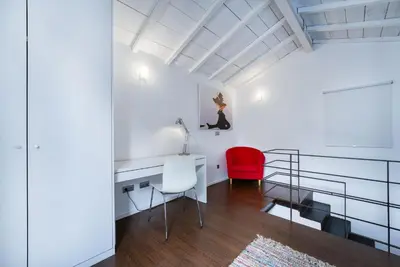 a room with a desk and a red chair at Fine Arts Studios by Olala Homes in Porto