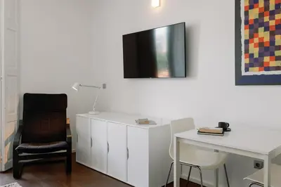 a white desk with a chair and a desk with a lamp at Fine Arts Studios by Olala Homes in Porto