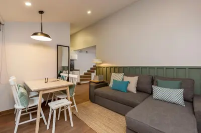 a living room with a couch and a table at Feel Porto Wine Essence Apartments in Vila Nova de Gaia