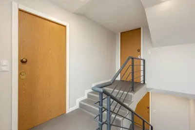 a staircase with a blue railing next to a door at Feel Porto Wine Essence Apartments in Vila Nova de Gaia