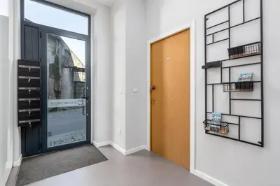an empty hallway with a door and a window at Feel Porto Wine Essence Apartments in Vila Nova de Gaia