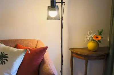 a room with a lamp and a table with a couch at Menina Colina Guesthouse in Porto