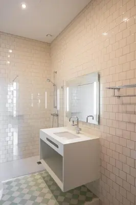 a white bathroom with a sink and a mirror at Menina Colina Guesthouse in Porto