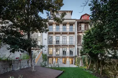 an image of a building with trees in front of it at Menina Colina Guesthouse in Porto