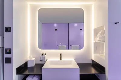 a bathroom with a white sink and a mirror at YOTEL Porto in Porto