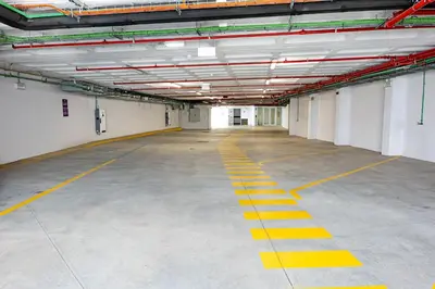 an empty parking garage with yellow lines on the floor at YOTEL Porto in Porto