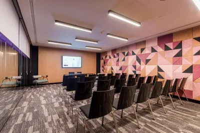 a conference room with chairs and a projection screen at YOTEL Porto in Porto