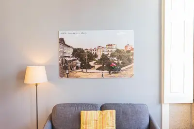 a living room with a couch and a picture on the wall at APOSENTUS - Your Home at Oliveiras in Porto